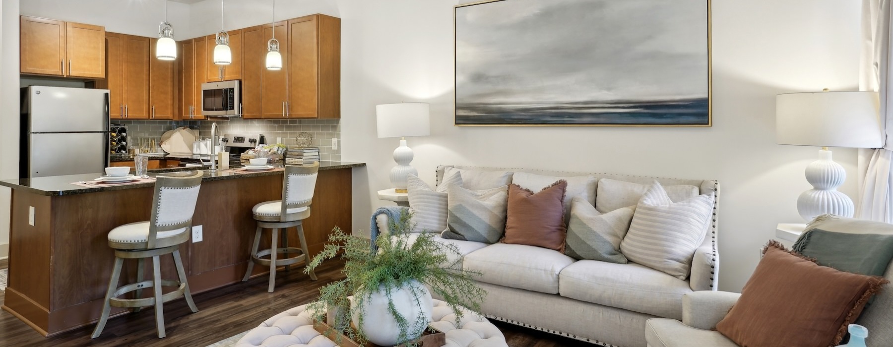 a living room with a couch, table and chairs