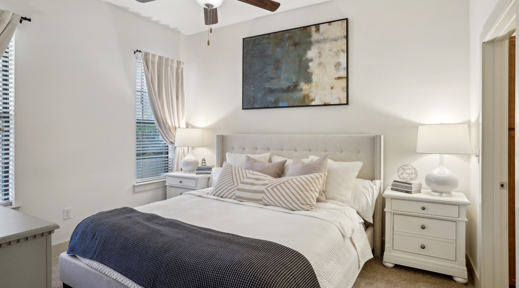 a bedroom with a bed and two nightstands