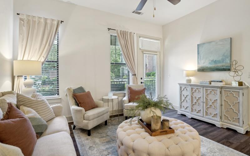 a living room with a fan and couches