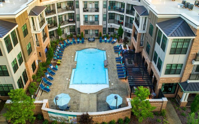 a pool in a courtyard between buildings